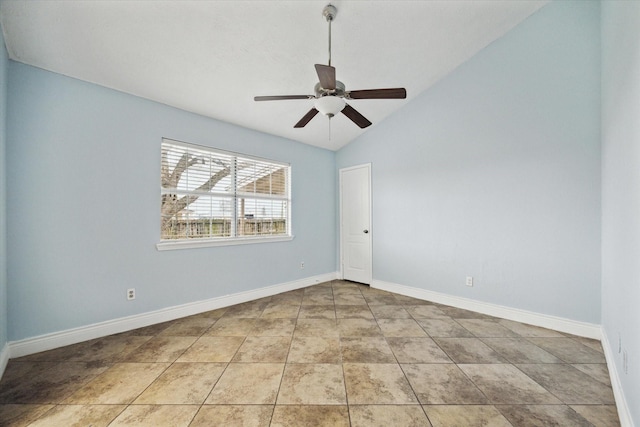 empty room with light tile patterned floors, ceiling fan, baseboards, and vaulted ceiling