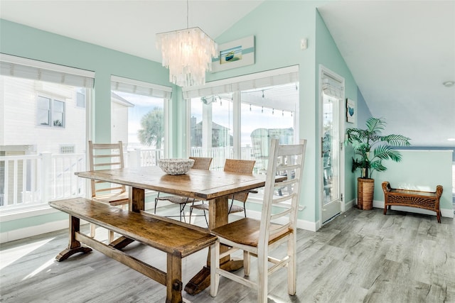 sunroom with lofted ceiling and a notable chandelier