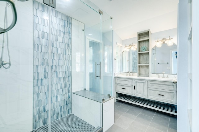 bathroom featuring double vanity, a shower stall, a sink, and tile patterned flooring