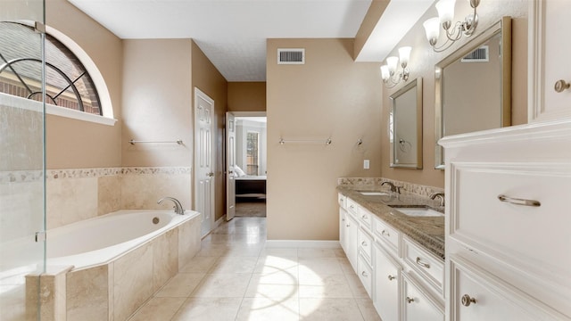 ensuite bathroom with a bath, visible vents, and a sink