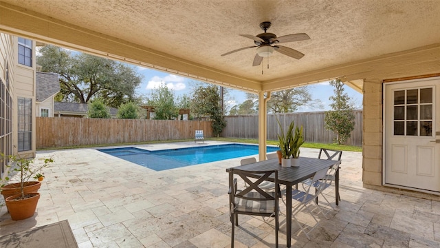 view of swimming pool with ceiling fan, a patio area, a fenced backyard, and a fenced in pool