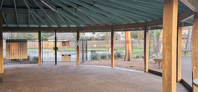 unfurnished sunroom featuring vaulted ceiling