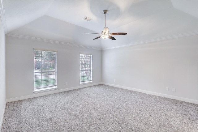 spare room featuring carpet floors, visible vents, baseboards, vaulted ceiling, and crown molding