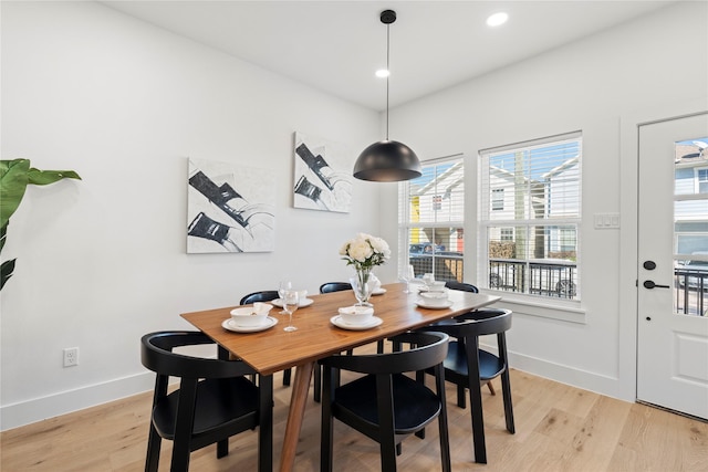 dining room with recessed lighting, baseboards, and light wood finished floors