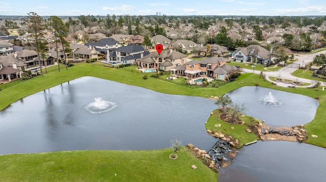 drone / aerial view featuring a water view and a residential view