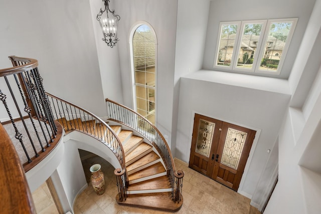 entryway with stairway and a chandelier