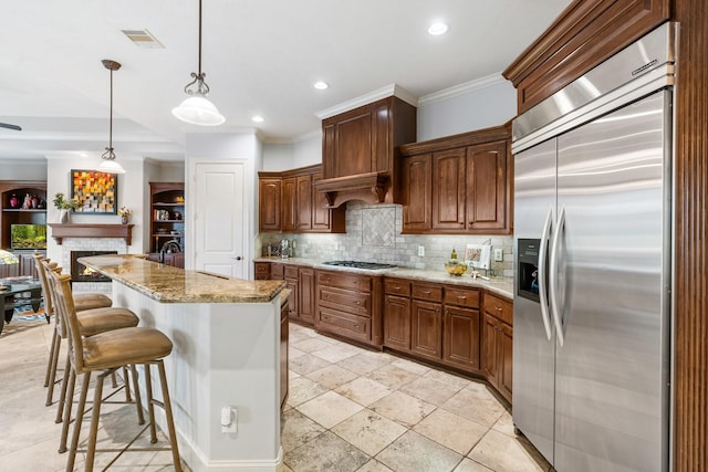 kitchen with a breakfast bar area, visible vents, ornamental molding, appliances with stainless steel finishes, and decorative backsplash