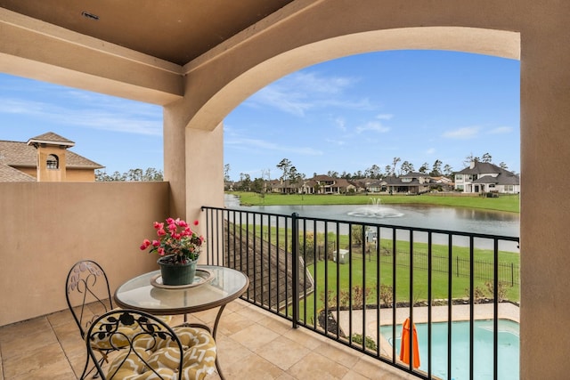 balcony featuring a water view and a residential view