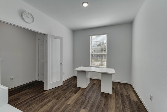 unfurnished office featuring dark wood-style floors and baseboards