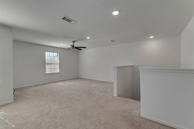 spare room featuring light carpet, baseboards, visible vents, a ceiling fan, and recessed lighting