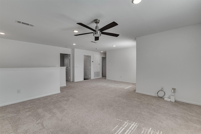 spare room featuring light carpet, baseboards, visible vents, a ceiling fan, and recessed lighting