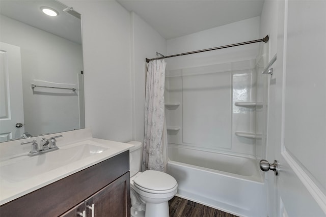 bathroom with toilet, shower / tub combo with curtain, wood finished floors, and vanity