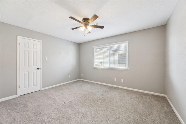 unfurnished room featuring a ceiling fan, carpet flooring, and a textured ceiling