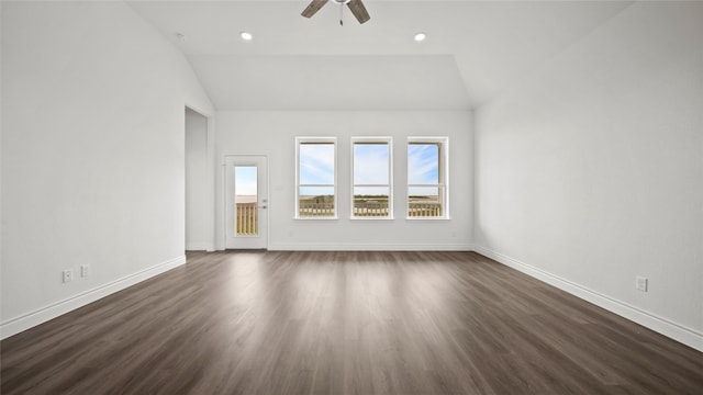 unfurnished living room featuring dark wood-style floors, baseboards, vaulted ceiling, and a ceiling fan