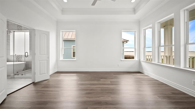 unfurnished bedroom with dark wood-style floors, baseboards, ornamental molding, and a raised ceiling