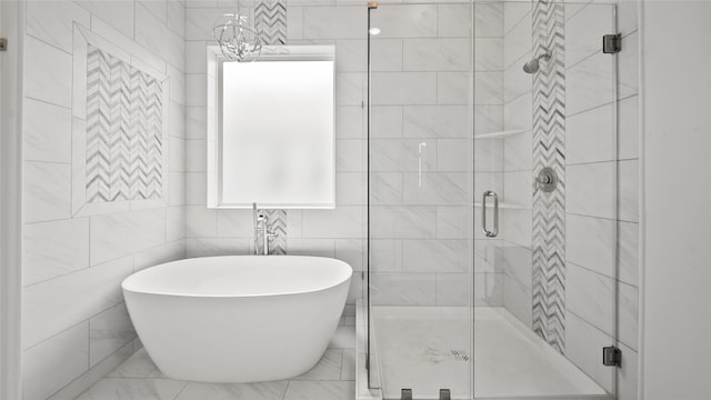 full bathroom featuring a soaking tub, tile walls, and a stall shower