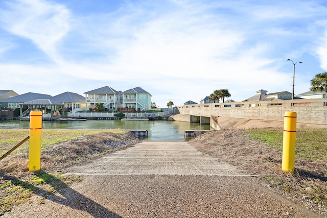 view of yard with a residential view and a water view