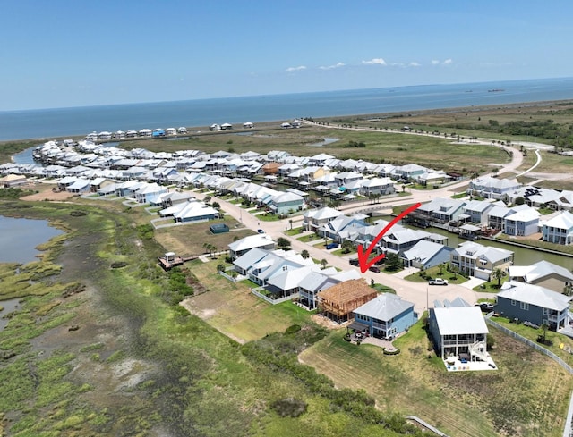 drone / aerial view featuring a water view and a residential view