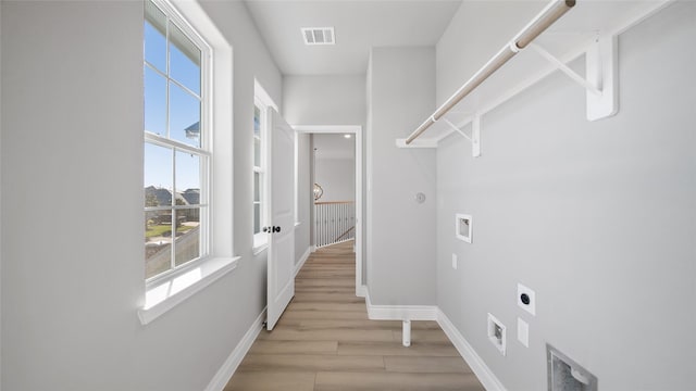 washroom with washer hookup, visible vents, light wood-style flooring, hookup for an electric dryer, and baseboards