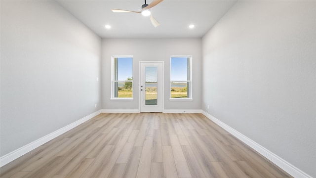 unfurnished room with a ceiling fan, light wood-type flooring, baseboards, and recessed lighting