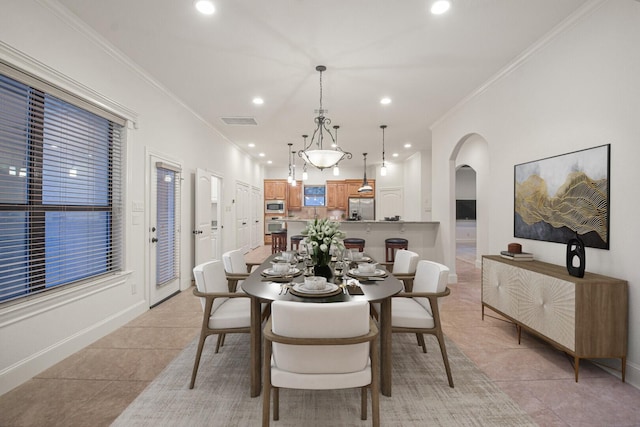 dining room featuring visible vents, arched walkways, ornamental molding, light tile patterned flooring, and recessed lighting