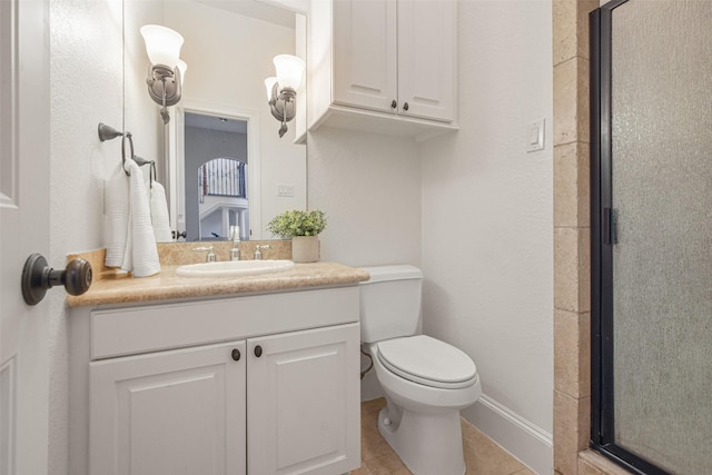 full bathroom with toilet, a stall shower, vanity, baseboards, and tile patterned floors