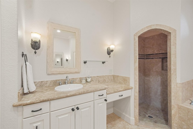 full bath with tiled shower, tiled bath, tile patterned flooring, and vanity