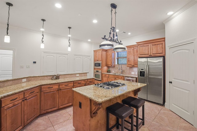 kitchen with brown cabinets, stainless steel appliances, tasteful backsplash, a kitchen island, and a kitchen bar