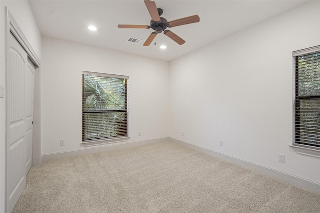 unfurnished bedroom with recessed lighting, light carpet, a ceiling fan, baseboards, and visible vents