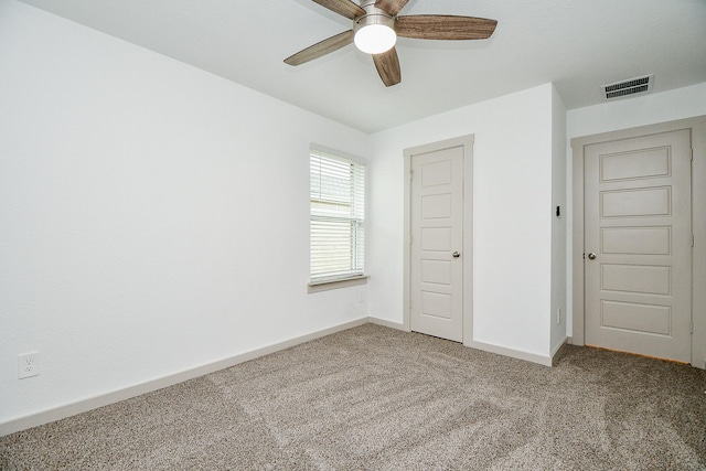 unfurnished bedroom featuring a ceiling fan, carpet flooring, visible vents, and baseboards