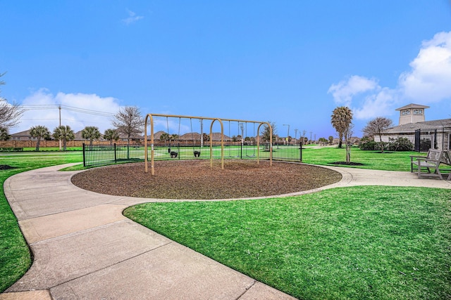 community play area with fence and a yard