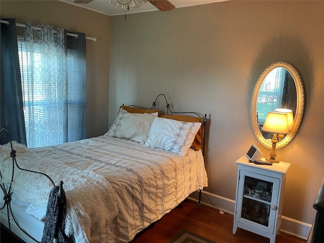 bedroom featuring dark wood-style flooring and baseboards