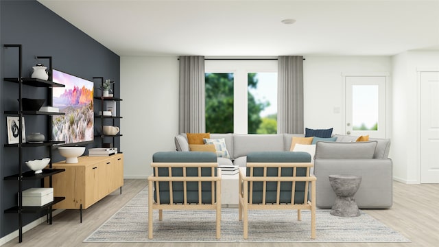 sitting room featuring baseboards and light wood-style floors