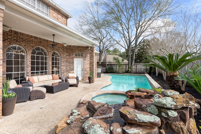 view of swimming pool featuring a patio, a fenced in pool, an in ground hot tub, a fenced backyard, and an outdoor hangout area