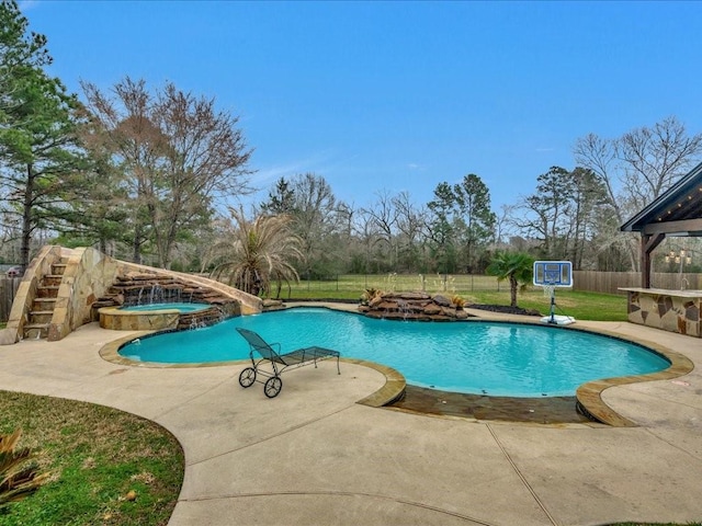 view of pool with an in ground hot tub, a patio, fence, and a fenced in pool