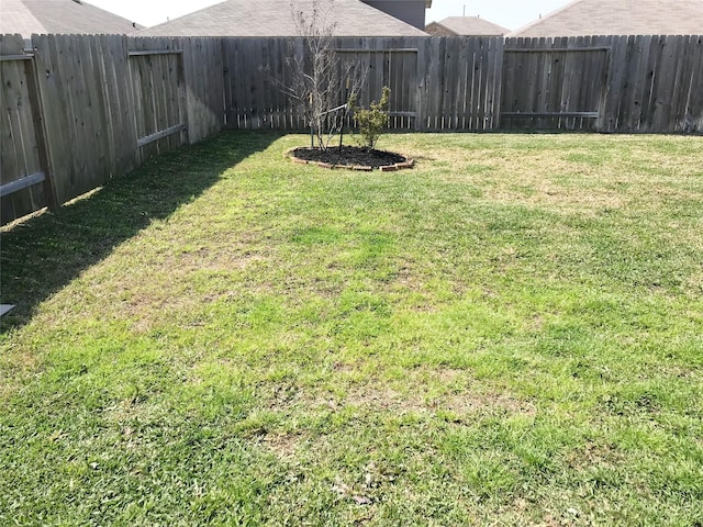 view of yard with a fenced backyard