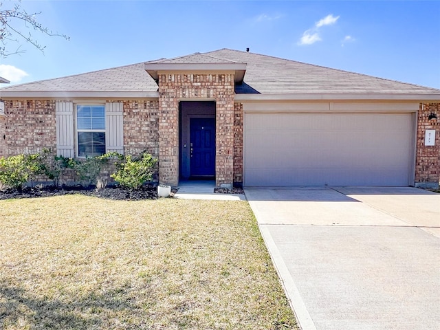 view of front facade featuring brick siding, a shingled roof, concrete driveway, an attached garage, and a front lawn