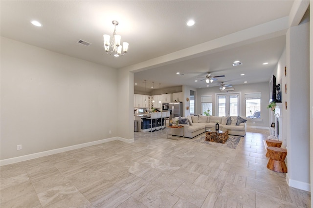 living area with baseboards, ceiling fan with notable chandelier, visible vents, and recessed lighting