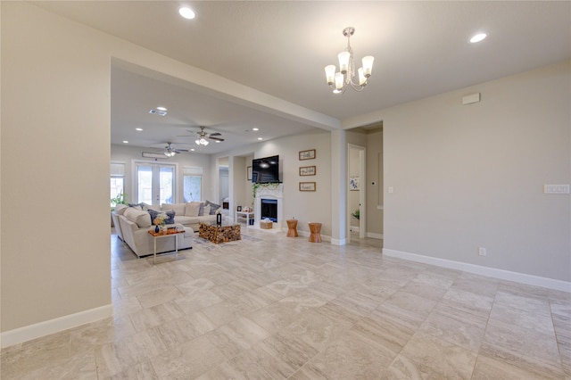 living room featuring recessed lighting, a fireplace, and baseboards