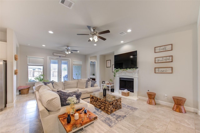 living room featuring a fireplace, visible vents, and recessed lighting