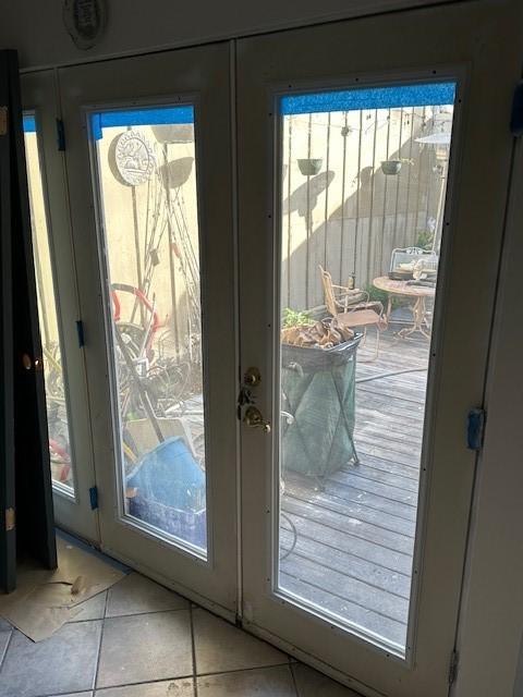 entryway with tile patterned flooring and french doors