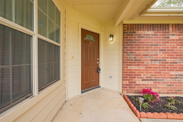 doorway to property with brick siding