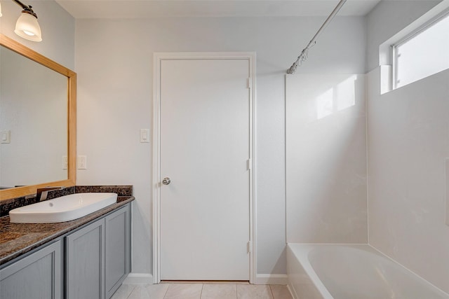 full bathroom featuring  shower combination, tile patterned flooring, and vanity