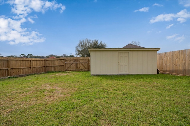 view of yard featuring an outbuilding, a fenced backyard, and a shed