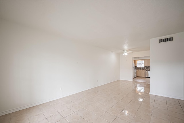 unfurnished room featuring visible vents, ceiling fan, baseboards, and light tile patterned flooring