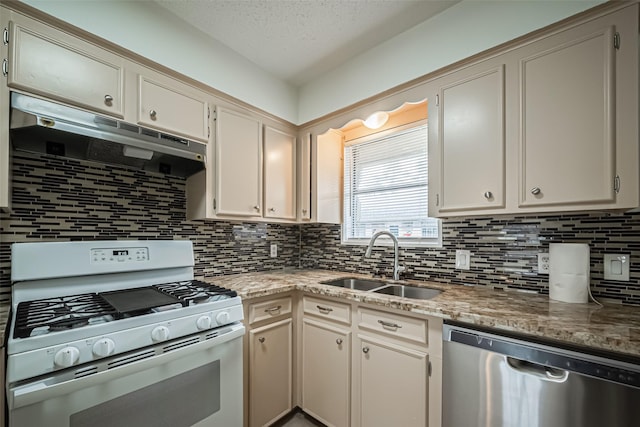 kitchen with white range with gas stovetop, dishwasher, light stone countertops, under cabinet range hood, and a sink