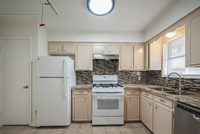 kitchen featuring decorative backsplash, a sink, light stone countertops, white appliances, and under cabinet range hood