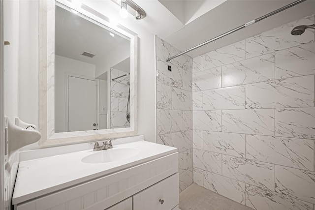 bathroom with visible vents, a stall shower, and vanity