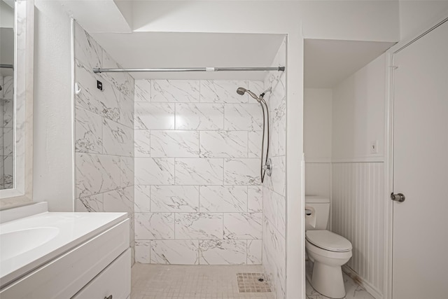 full bathroom with a shower stall, vanity, and toilet