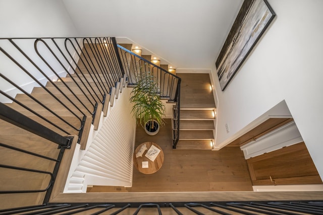 stairway featuring wood finished floors